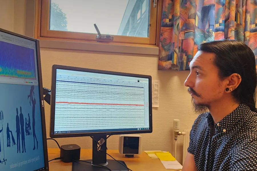 Alberto Jaramillo Jiménez sitting at a desk with several monitors